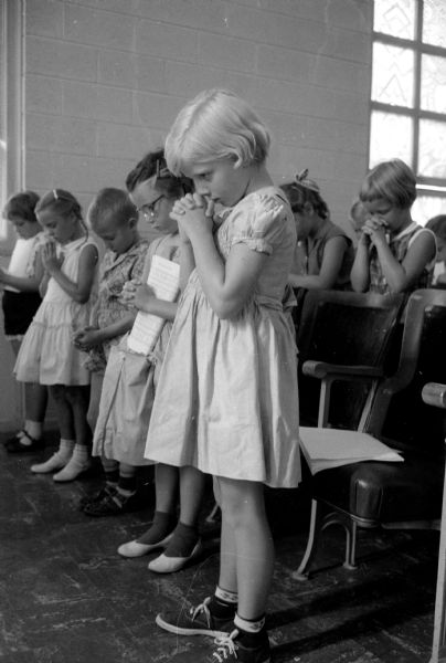 Children attend the summer Bible school session at the Midvale Community Lutheran Church on 4329 Tokay Boulevard. Bowing their heads in prayer, they are (left to right): Anne Rosen (77 Merlham Drive); Kathleen Curran (541 Togstad Glen); Stephen Thielke (474 S. Midvale Boulevard); Mary Sue Strauss (4409 Boulder Terrace); and Christine Orr (654 Charles Lane).