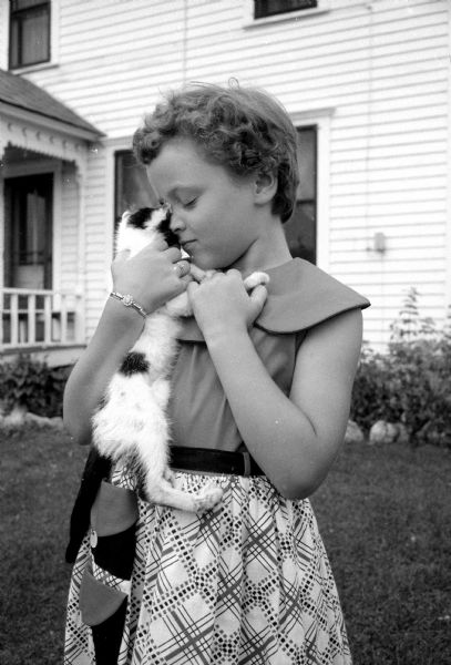Barbara Notstad holding one of the ten kittens on the family farm that she will miss when she goes to school for her first year at Rockdale School near Cambridge.