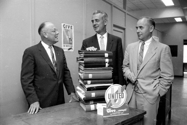Officers of United Givers' Fund Drive look over the budgets submitted by various member organizations. From left are Charles N. Goulet, Francis Holford, and R.A. Eissfeldt.