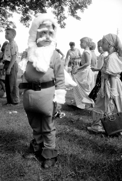Santa Claus and some gypsies put in an appearance at the Truax Field Playground Costume Party. Santa was John Terry.