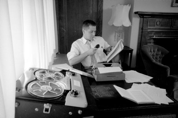Pierre du Vair, a June graduate from Notre Dame University, is shown working at his typewriter and tape recorder preparing for graduate study in economics at the University of Wisconsin.