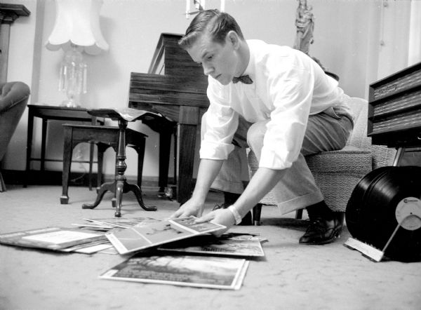 Paul du Vair, a hi-fi enthusiast, is shown checking over the vinyl records he plans to take to St. Norbert College this fall.