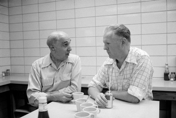 Employees of the new City-County Building enjoying refreshments in the canteen. They are Walter Beck (left) and Jelmer Anderson.  