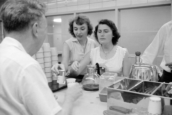Employees of the new City-County Building enjoying refreshments in the canteen. Lloyd Harmon (left), operator of the canteen, is serving paper to-go cups to Marilyn Hummel (of Columbus) and Henrietta Thompson (of Rio).