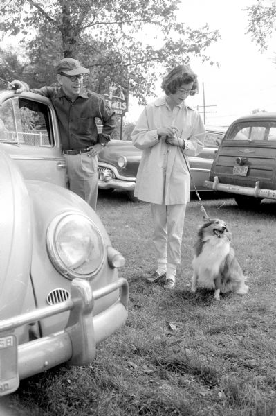 Participants in the 4th Annual Dog Obedience Trials held at the Double A Arena near Cambridge. Shown from left to right are: Charles R. Manley, Jr. (3847 Clover Lane) and his daughter Tracy. Their Shetland Sheepdog, Woody, sits at attention.