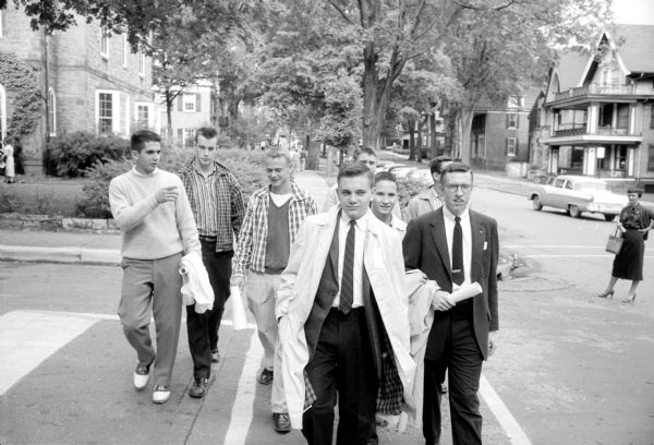 Group of men on Langdon Street either participating in Fraternity Rush or watching women participate in Sorority Rush.
