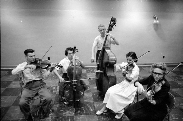 The five principal string players of the Madison Civic Symphony orchestra at rehearsal in Scanlan Hall. Left to right are: Ernest Stanke, viola; Phila Rafoth, cello; Walter Fandrich, double bass; Anne Prindle, second violin; and Marie Endres, first violin. 