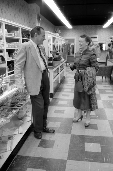 Anne Marshall Kleist with her husband, Al, ready to close up her ladies' ready-to-wear and accessories store, Kleist and Wiggs, for the day.