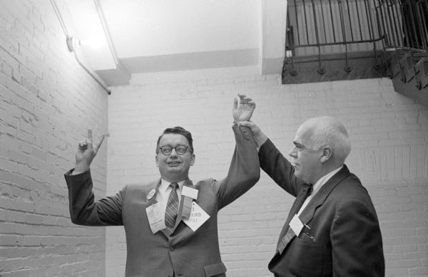 The winner of the race for State Chairman of the party is Patrick J. Lucey (left), shown here with the incumbent chairman, Philleo Nash of Wisconsin Rapids. Lucey defeated Nash in the election by a vote of 692-687 at the State Democratic Party Convention held at the Hotel Loraine.     