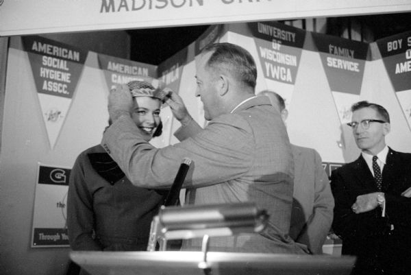 Miss America, Marilyn Elaine van Derbur, being crowned "Madison's Miss 1957 United Givers' Fund Queen" at the charity's banquet during the Madison stop on her tour of the country.