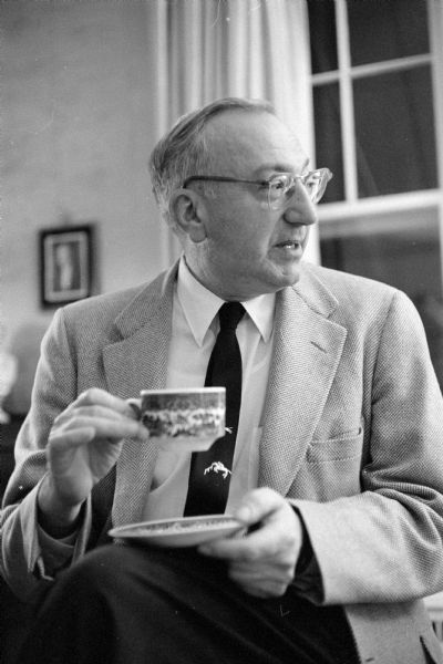 Portrait of Dr. John A. Schindler, Monroe physician and author, holding a coffee cup and saucer. Two of the books he wrote were <i>How to Live 365 Days a Year</i> and <i>Woman's Guide to Better Living 52 Weeks a Year</i>. The doctor was killed in an automobile accident on November 16.

