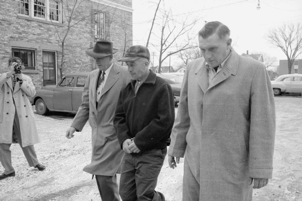 Law enforcement officials escorting Ed Gein to the State Crime Lab, 917 University Avenue, for lie detector and other tests.