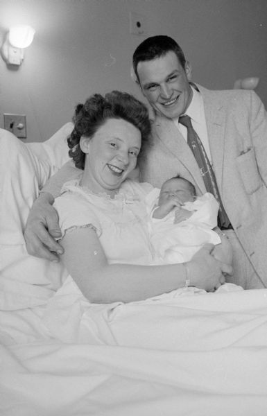 Newborn baby boy with his parents, Mr. and Mrs. Donald Dohm. He was born at 12:07 a.m., the first baby born in Madison in 1958.