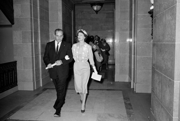 Mrs. Gaylord Nelson (Carrie Nelson) as she accompanies her husband, Gaylord, to his office after his inauguration at the State Capitol.