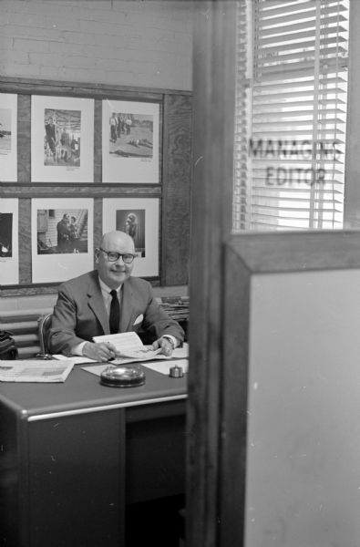Lawrence Fitzpatrick, Managing Editor of the <i>Wisconsin State Journal</i>, is seen sitting at his old desk at Journal office.