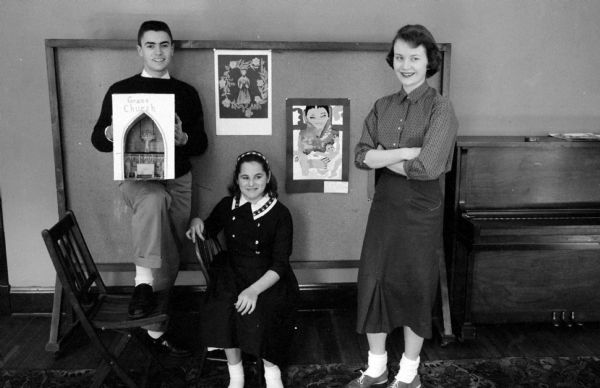 Ruthy Saunders (center, 831 Prospect Place) and her painting "Prayer" won the first-place prize in the centennial art competition at Grace Episcopal Church. Robert Reznichek (left, 1245 Morrison Street) won second place with his painting "Grace Church Interior." Frances Webber (right, 2814 Van Hise Avenue) is director of the Grace Church art workshop. The winners are pictured with their winning art work.