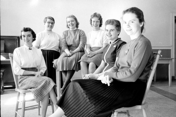 Sitting are six young women who won scholarships presented by the Woman's Club of Madison. Left to right are: Sandra Jean Breitzke, Judith Davies, Lorraine Johnson, Ruth Olson, Marilyn Detter, and Jan Rosen.