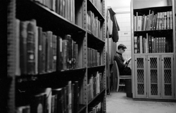 University of Wisconsin student Richard Merkel (1925 West Lawn Avenue) conducts research work in a U.W. Memorial Library carrel off of the book stacks.