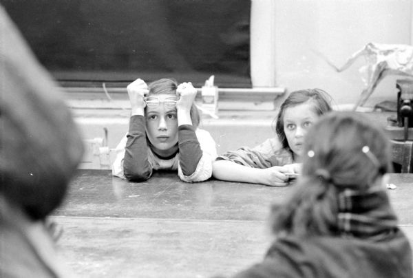Students watching a movie about a circus to get ideas at a Saturday art class for children run by the University of Wisconsin Art Education Department.