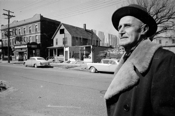 Joseph Young standing across the street from his nearly-dismantled Young's Restaurant at 622 West Washington Avenue. The restaurant was operated by Young, his wife and other family members for 37 years. It will be replaced by a gas filling station. A drug store is a couple buildings to the left.