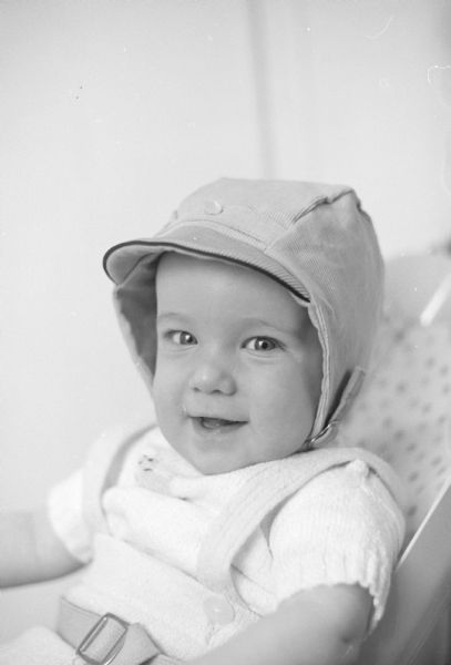 6-month-old William Bradford Johnson, son of Mr. & Mrs. Graham Johnson, is shown in his head gear for Easter, a blue corduroy cap.