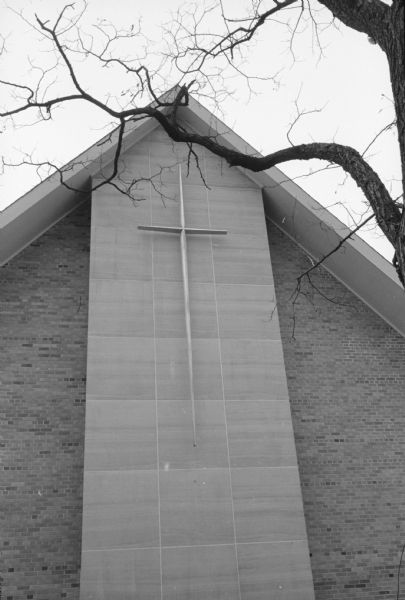 Newly installed metal cross on the exterior of the recently completed sanctuary of Bethany United Methodist at 3910 Mineral Point Road. The aluminum cross was designed by Howard Packard, a sculptor of metals, whose works had won him national attention. The cross was cast at Madison Brass Works and finished by hand by the sculptor.  
