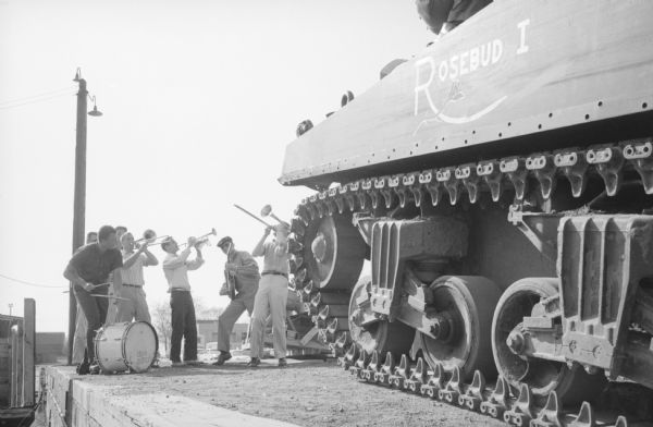 Delta Sigma Pi fraternity purchased a used 33-ton Sherman tank from Camp McCoy for use at a spring fraternity "tank party". The fraternity's Dixieland orchestra salutes the tank's arrival at the Milwaukee Road depot. After the party, the tank will be donated to a veterans' group for use as a war memorial.    
