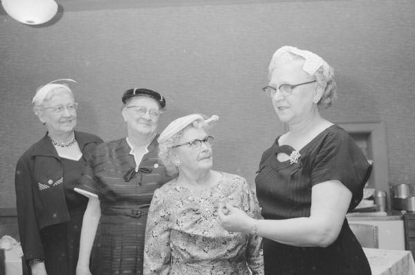 Pins for 40 years of membership in the grand international auxiliary to the Brotherhood of Locomotive Engineers were presented by, at extreme right, Mrs. Charles Adams, president of the Madison auxiliary, to Nora Thiede; Mrs Vernon Gilbert, Fairchild; and Anna Nelson.  