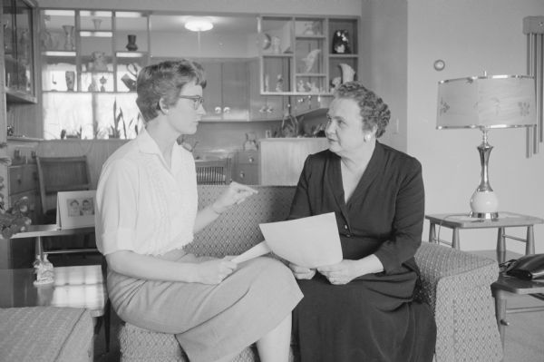 Kathleen Russell, Iowa County home agent, left, meeting with Mrs. Milton Leix, Cobb, president of the county homemakers organization.