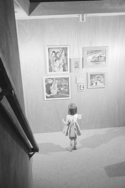 New home, located at 4121 Chippewa Drive, designed by owners Martin and Ann Wolman to meet the needs of their large family of five children. Shown is daughter, 3 1/2 year old Mary Ellen, viewing art work in the home's gallery area near the entrance.     