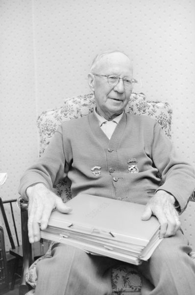 William F. Schroeder is shown holding an album containing medals he won as a bicycle racer in the 1890s. He raced at Darlington in 1895; at Platteville  in 1896 and a muddy Sun Prairie-to-Madison in the 1890s. Before moving to Madison he was a fireman and businessman in Platteville from 1892 to 1949.