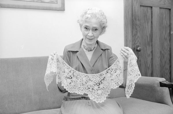 Annie Barnes displays a wide lace collar (called a bertha) that was part of her wedding dress. She had handmade it herself in six weeks using sewing needle and thread before her 1906 wedding to Roscoe Barnes.
