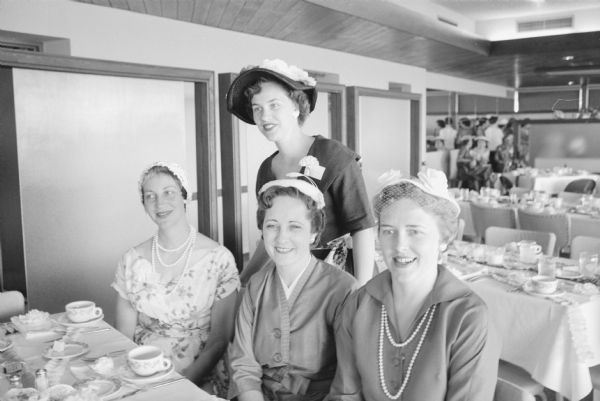 Members of the Who's New Club for new women residents in Madison hold their annual spring luncheon at the Nakoma Country Club. Shown seated (L-R) are: Mrs. Patrick Kelly, 3466 Dawes Street, club program chairman; Mrs. Lester Comstock, 701 Seneca Place, club sunshine chairman; and Mrs. Kenneth Disch, 537 Togstad Glen, club publicity chairman. Shown standing is Mrs. Verner Ekstrom, 141 Craig Avenue, member of the club board of directors and program committee.   