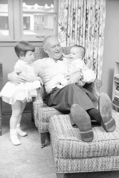 Grandfather Arthur Towell, 4126, Iroquois Drive, spends time with his grandchildren Jean Ruth (2) and William Arthur (4 months), children of Mr. and Mrs. Thomas Towell, 657 York Street.