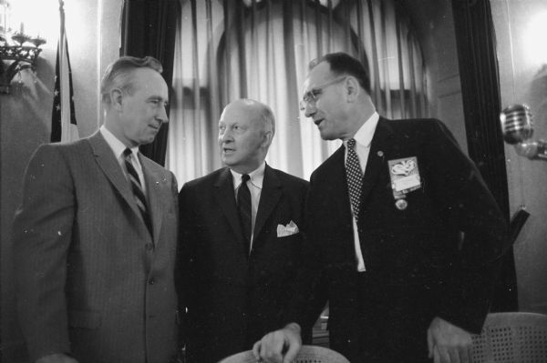 Chatting at the luncheon business meeting of the National Forest Products Research Society are, from left: Governor Vernon W. Thomson; George H. Roderick, assistant secretary of the army; and F.H. Kaufert, University of Minnesota, outgoing president of the society.