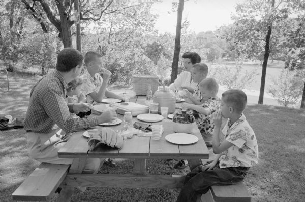 The Frank J. Remington family enjoying a picnic in their backyard.