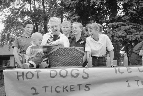 Some of the 200 attendees at the hot dog stand in Burrows park for the picnic sponsored by the Dane county Republican Women and the Young Republicans. From left are: Lois Nuernberg, Jon Forsberg (age 4), Mrs. Dena Smith, Whitney Gould, Solveig Bjorke, and Ruth Cottrell. 