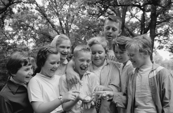 A group of kids admire a mushroom that Francis Burns found on a log at the Olin day camp.