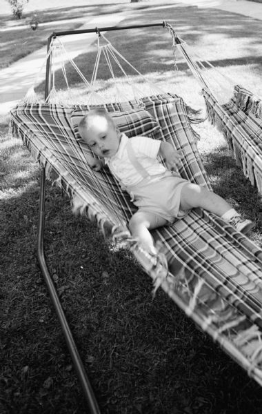 Jimmie Stein, two year old son of photographer Edwin Stein, lying in a hammock.  