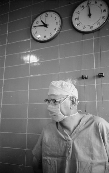 <i>Wisconsin State Journal</i> reporter John Newhouse is shown in Wisconsin General Hospital operating room garb as he reports on a new drug developed in Wisconsin and used during a delicate brain surgery operation.   