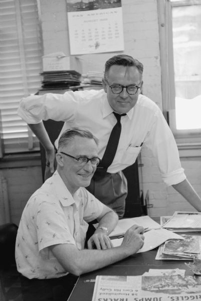 Herald McClelland (seated) the <i>Wisconsin State Journal</i> Editor, and John Prindle (standing) the <i>Wisconsin State Journal</i> Assistant State Editor.