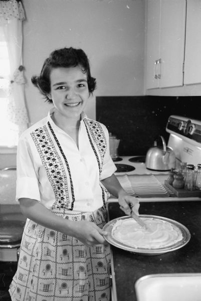 Agnes Tomlinson, Middleton, cuts a strawberry pie. She plans to enter the cookbook recipe contest for the <i>Wisconsin State Journal</i>.