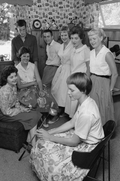 Committee members in charge of "Summer Farewell", a teen-college age dance to be held at the Nakoma Golf Club. In the foreground is Karen Mickelson holding a golf club, publicity chairman. Others are, left to right: Alice Dean, Linda Garrott, Jay Smith, Lyndon Allin, Mary Jay Staab, Pat Patterson and Barbara Werth.