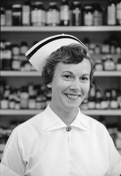 Marguerite Yunger posing in a nurses hat at Madison General hospital where she is a staff nurse. She also is president of the women's auxiliary to Typographical Union 106. Her husband, Joseph W. Yunger, is employed in the printing plant of the Credit Union National Association.