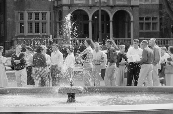 University of Wisconsin students meeting others at the new fountain on the library mall on campus. The University Club building is in the background.