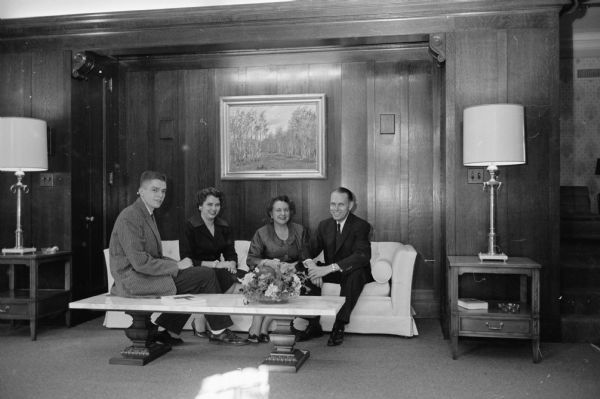 University of Wisconsin president Conrad A. Elvehjem, his wife, son, and daughter seated in the Tudor living room of the official residence.