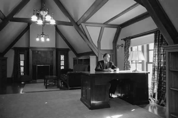 University of Wisconsin president Conrad A. Elvehjem seated in the peaceful, quiet study on the third floor of Olin House, the official residence.