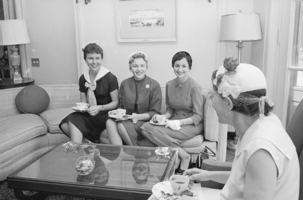 Members of the Madison Dental Hygiene Association hold a tea at the Governor's Mansion in Maple Bluff. Shown (L-R) are: Sue Winker, 216 West Gilman Street; Mary Klinge, 220 N. Thornton Avenue; Kathleen Kubash, 216 W. Gilman Street; and Mrs. Francis Wold, 234 Dunning Street.