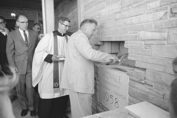 Members of the Midvale Community Lutheran Church, 4329 Tokay Boulevard, lay  the cornerstone for their new church building. Shown standing at the cornerstone box are, (L-R): Earl Stolper, 42 S. Owen Drive, president of the congregation; Rev. Sig G. Sandrock, pastor; and Leo Jenness, general contractor for the building project.