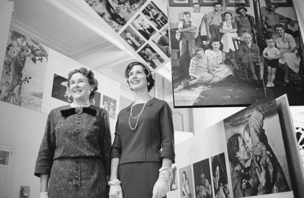 Members of the Madison Art Association and the Women's Auxiliary of the State Historical Society get a preview of "The Family of Man" photographic exhibit at the main floor gallery of the Historical Society building. Shown viewing the exhibit are, (L-R): Mrs. Robert Boussard, 1173 Farwell Drive; and Mrs. Robert Bolz, 401 Woodward Drive.